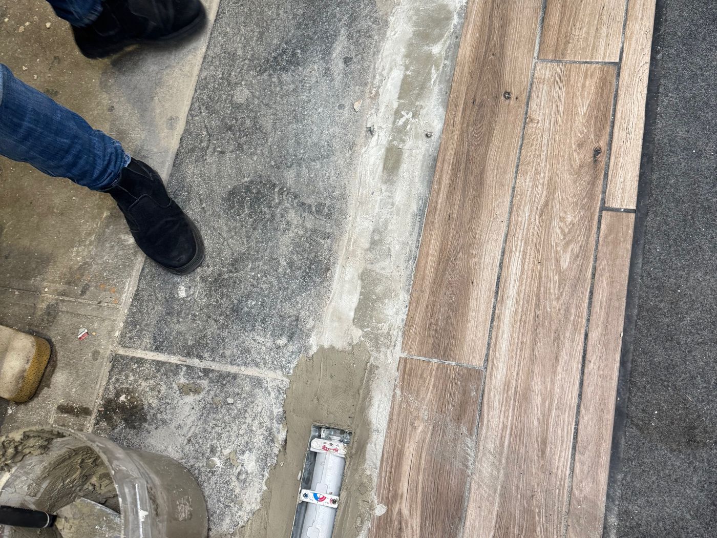 New floor closer set in a freshly re-poured cement pit at the storefront entrance