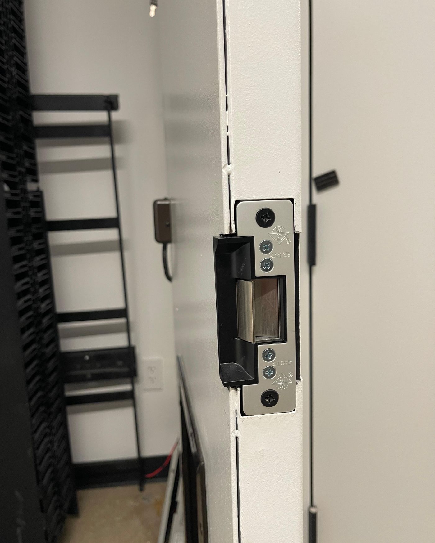 Electronic door entry hardware installed on a commercial door